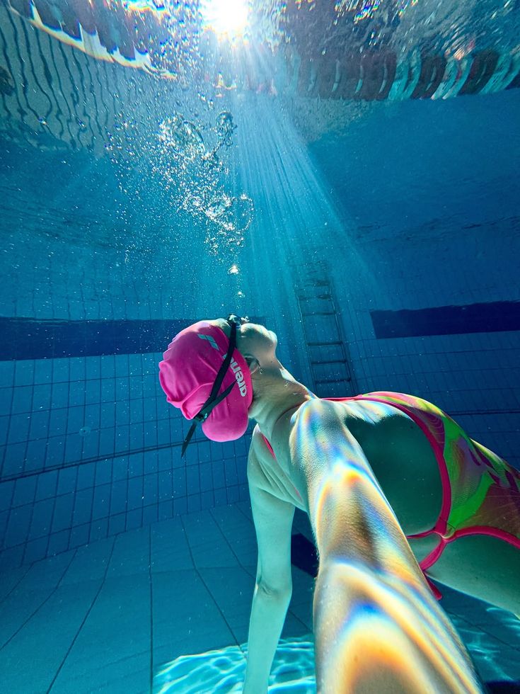 Person underwater with light coming through the surface
